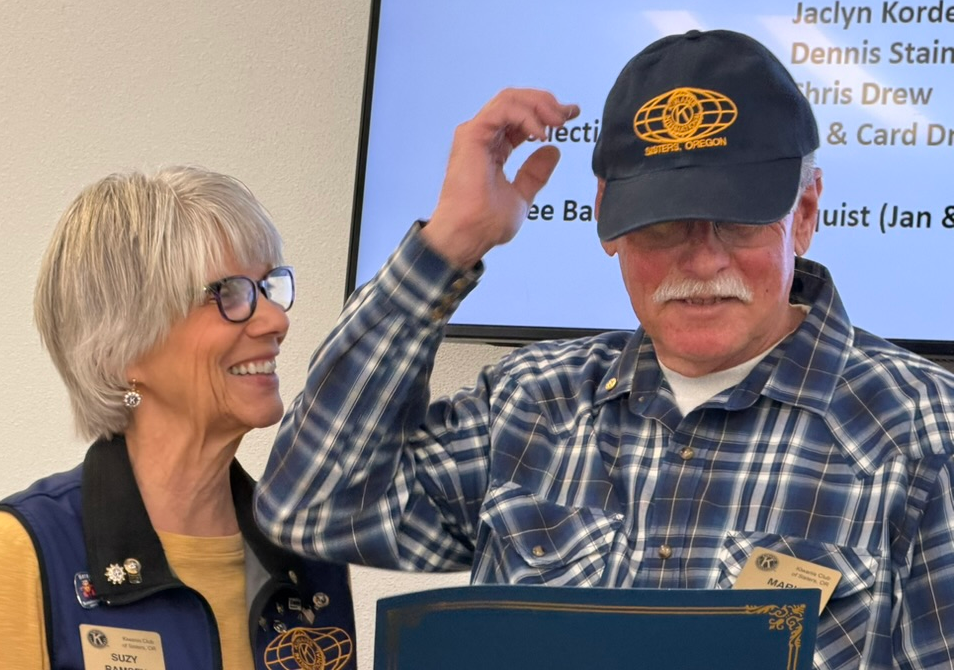 Mark Mew new member induction sporting stylish Kiwanis ball cap
